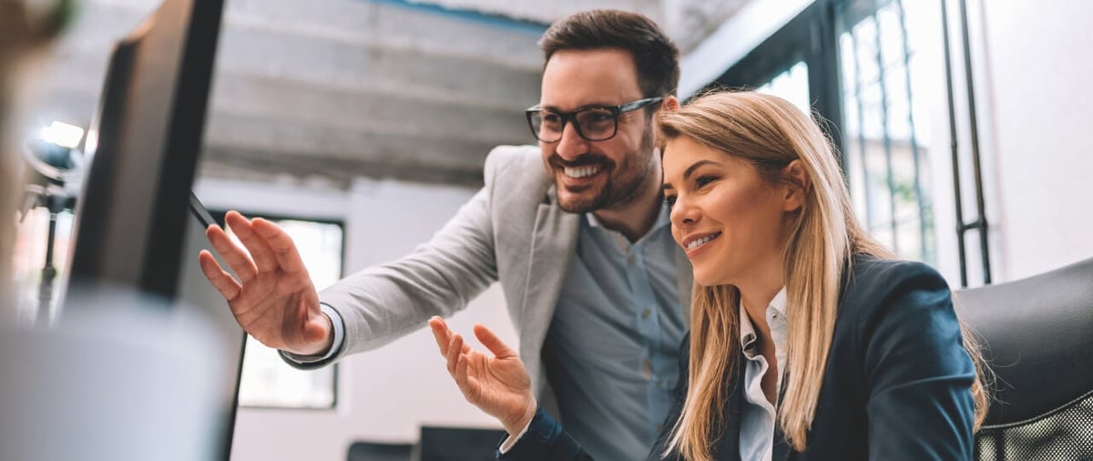 Header-Man and woman looking at screen comparing data